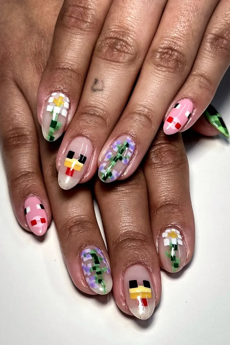 a close-up of woman's nails with minecraft inspired nail look