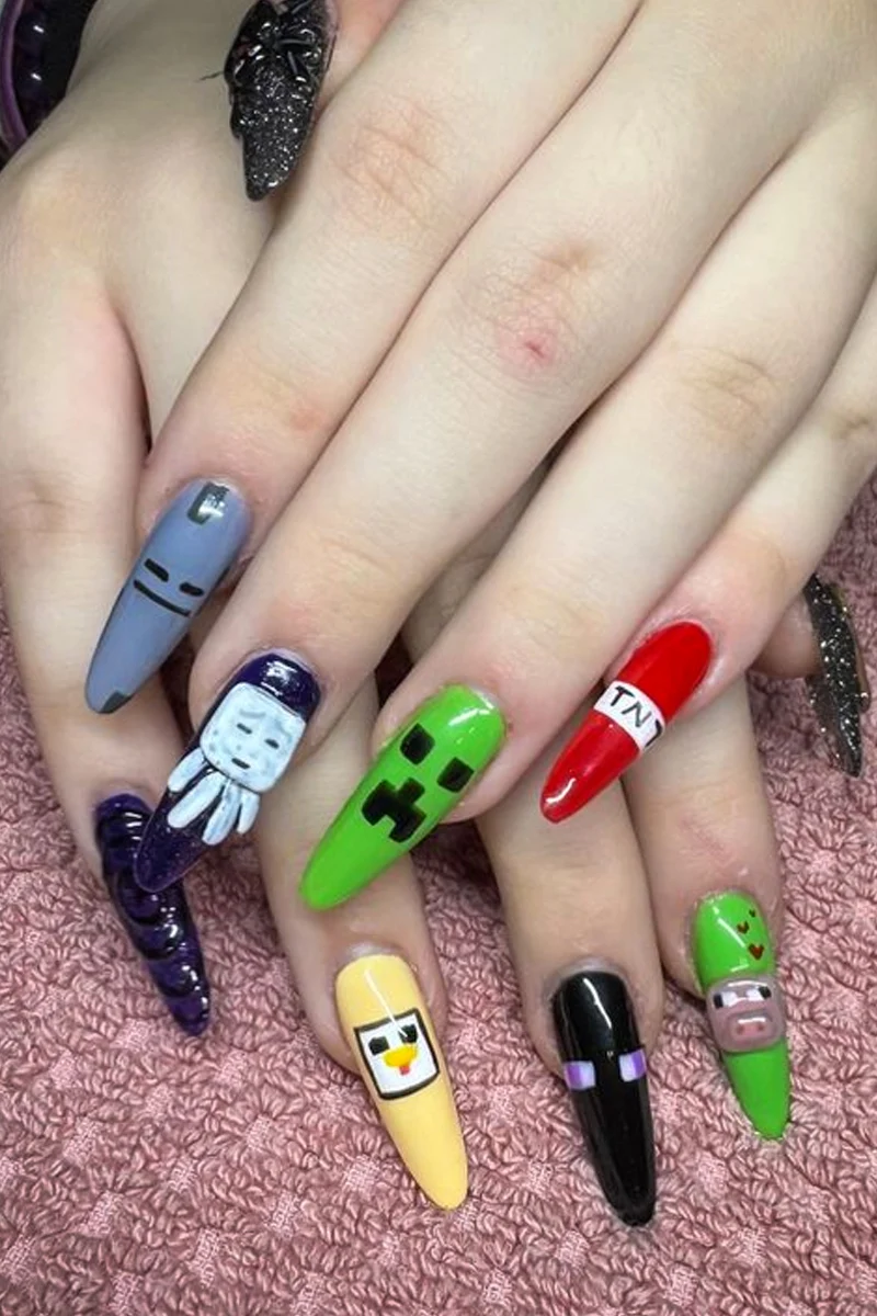a close-up of woman's nails with minecraft inspired nail look