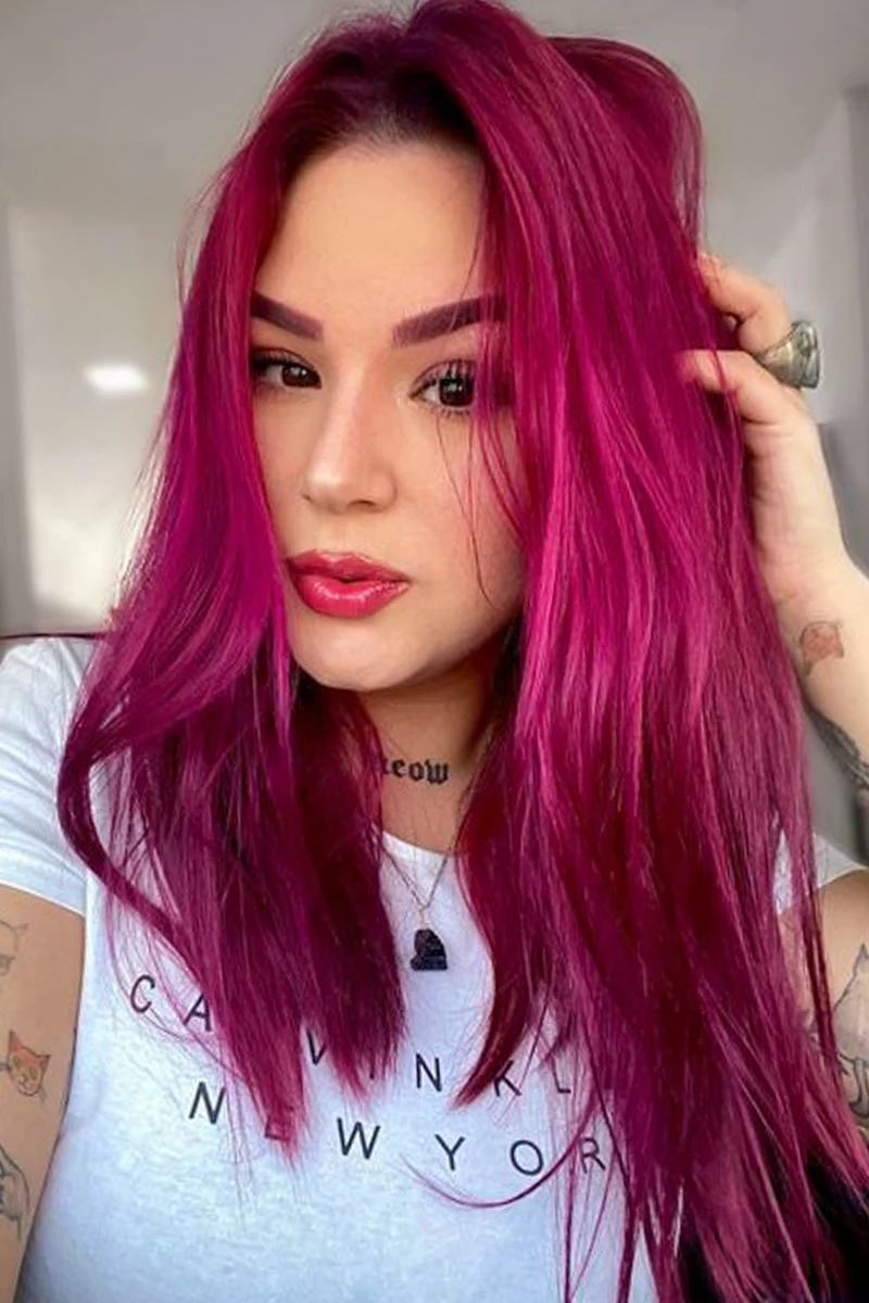 a portrait of a beautiful woman with a dark fuchsia hair