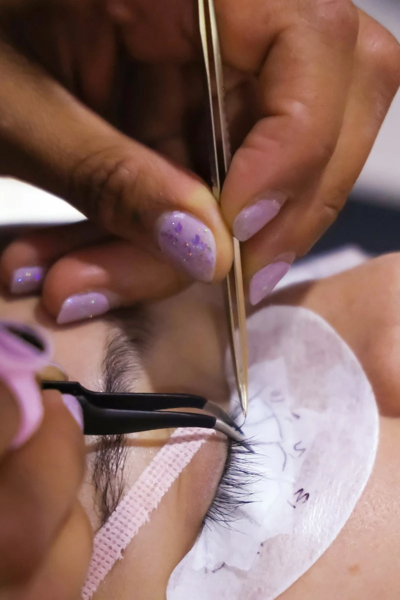 professional eyelash extensions application on woman's eye